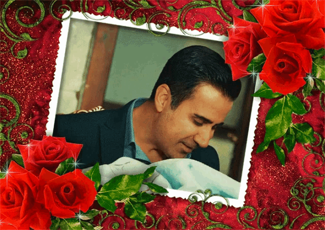 a picture of a man holding a baby in a red frame with red roses