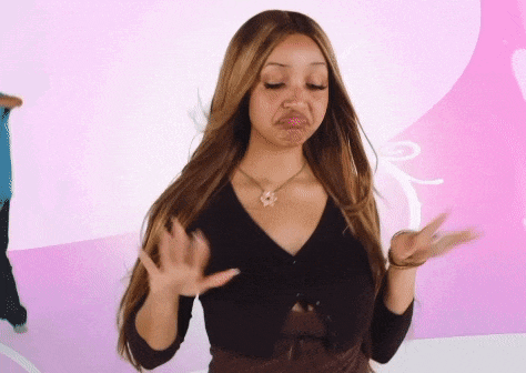 a woman with long hair and a necklace is making a face