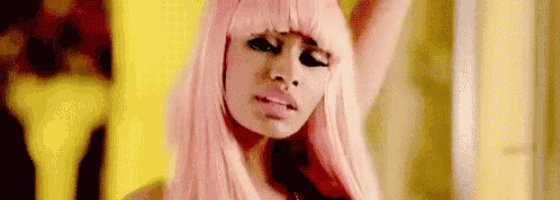 a close up of a woman wearing a pink wig and a yellow background .