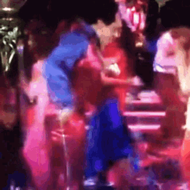 a blurry picture of a group of people dancing in a club