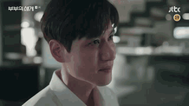 a close up of a man 's face with the jtbc logo in the background