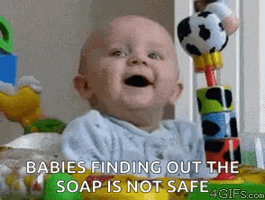 a baby is smiling while sitting in a crib with toys and says babies finding out the soap is not safe .