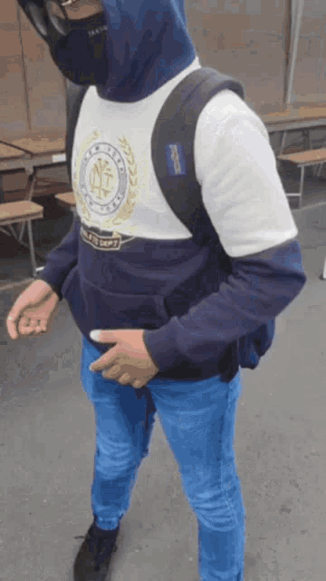 a man wearing a mask and a jansport backpack walking