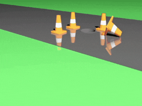 a group of orange and white traffic cones on a road