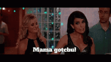 two women are standing next to each other and one of them says mama gotchu .