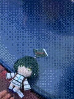 a person is holding a stuffed doll with a book in her hand