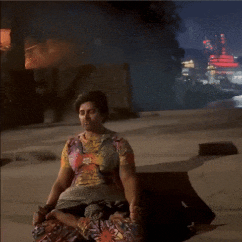 a woman sits on the ground with yash birla written in white