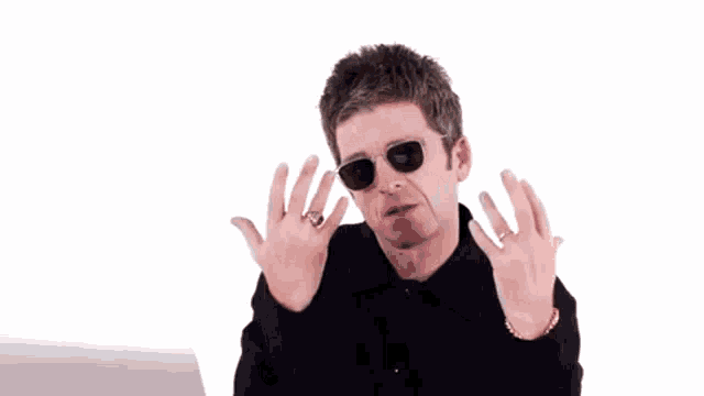 a man wearing sunglasses and a black shirt is making a face