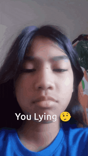 a girl in a blue shirt says " you lying " next to a sad smiley face