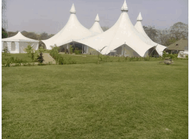 a white tent with a john deere logo on the side
