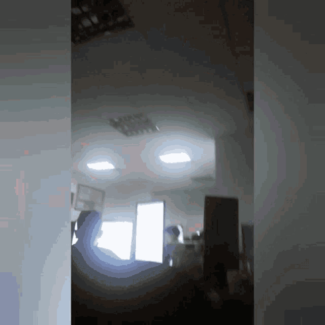 a blurred image of a room with a ceiling light