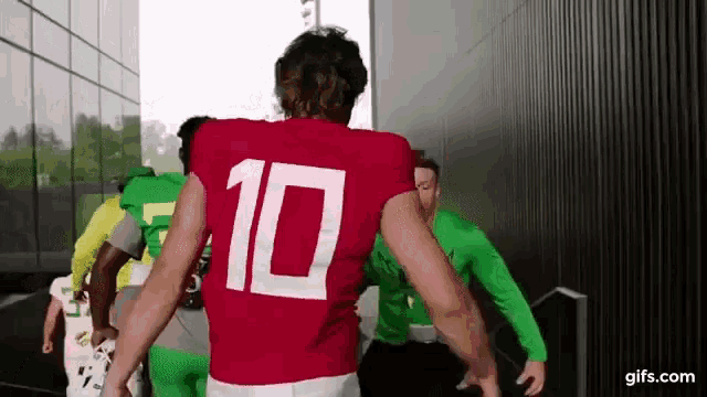 a man in a red jersey with the number 10 on the back