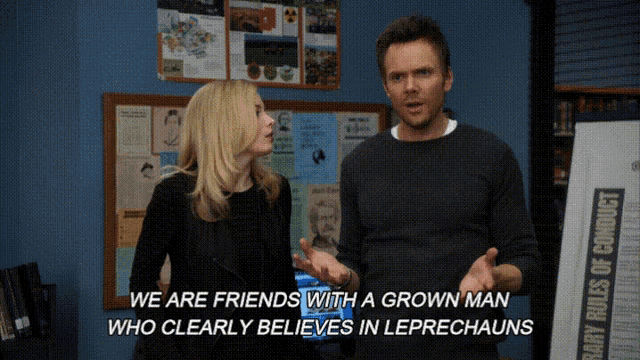 a man and a woman are standing in front of a bulletin board that says " we are friends with a grown man "