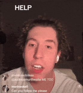 a man with curly hair is asking for help while wearing headphones