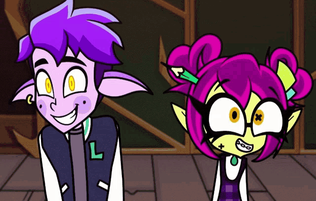 a boy and a girl are standing next to each other and the girl has a letter l on her jacket