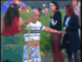 a blurry picture of a group of people including a woman wearing a shirt that says ' i love you ' on it