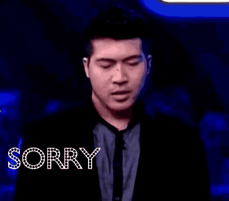 a man with his eyes closed and the word sorry above him