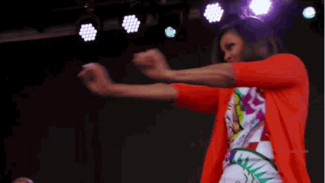 a woman in a colorful dress is dancing on a stage with the hashtag #sytvcd premiere
