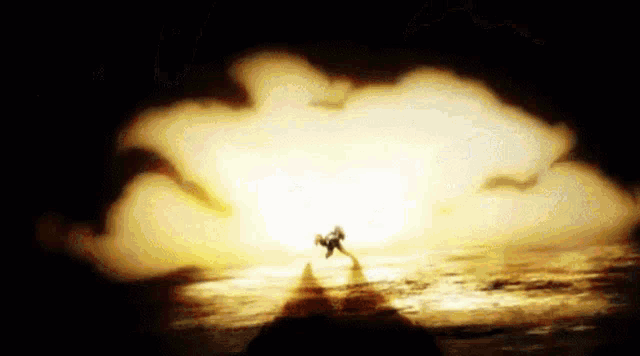 a person is standing in front of a large explosion in the sky .