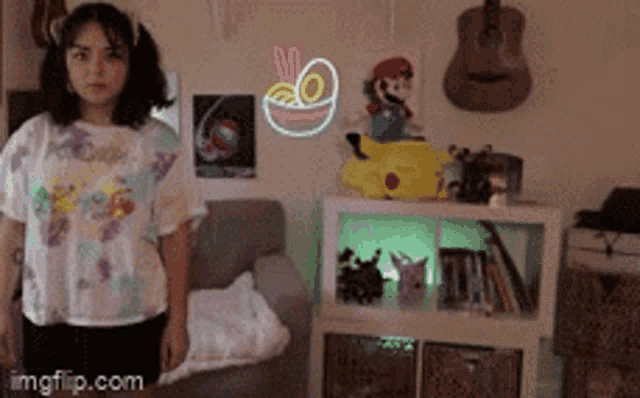 a girl is standing in a room with a neon sign on the wall that says no noodles