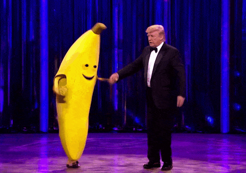 a man in a tuxedo is standing next to a banana mascot