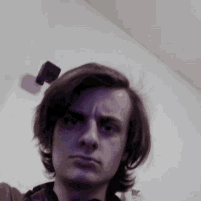 a man taking a selfie with a camera on his neck