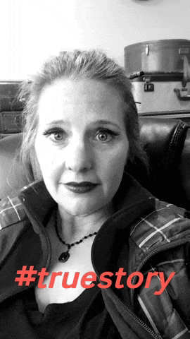 a woman sitting on a couch with #truestory in red letters behind her