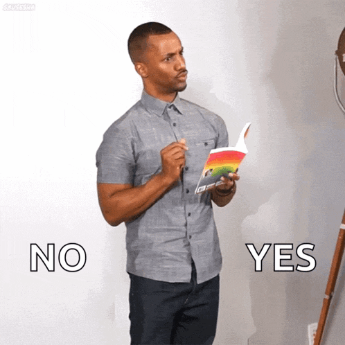 a man in a grey shirt holds a book in his hand and says no and yes