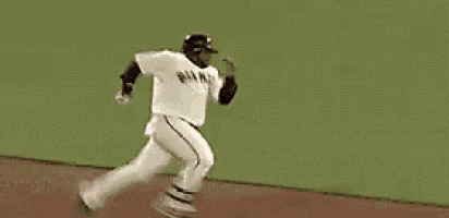 a baseball player is jumping in the air to catch the ball