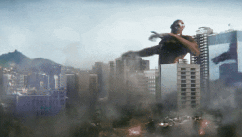 a giant monster is flying over a city with smoke coming out of it