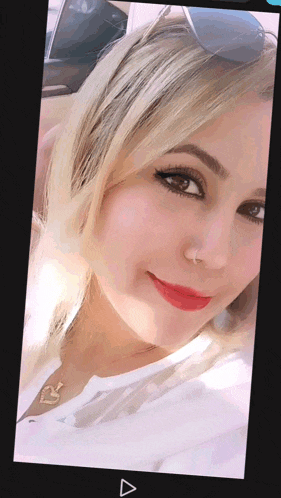 a close up of a woman 's face with a heart necklace