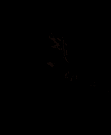 a man with a beard is laying in the dark .