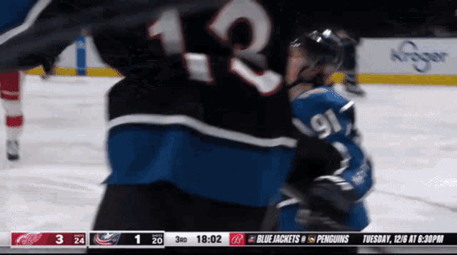 a hockey game between the blue jackets and the penguins is being played
