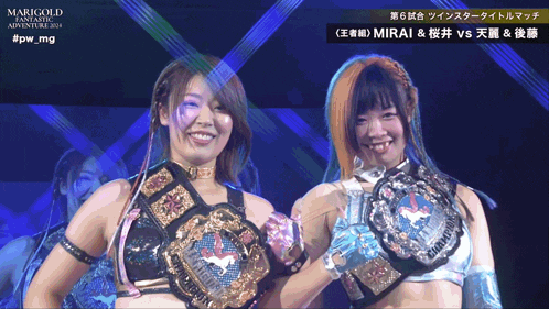 two female wrestlers are standing next to each other in front of a sign that says pw mg