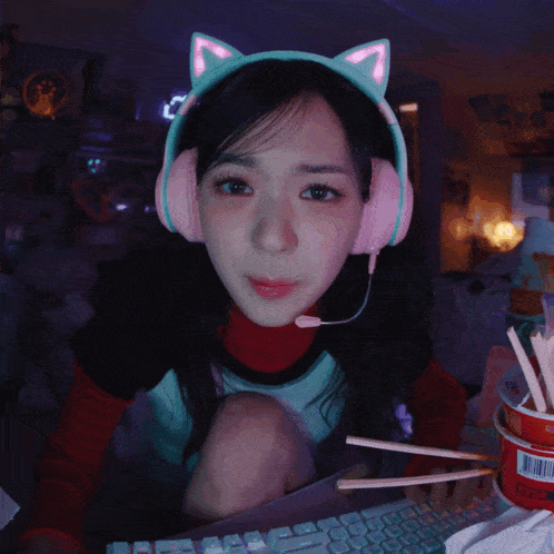 a girl wearing headphones and a headband with cat ears