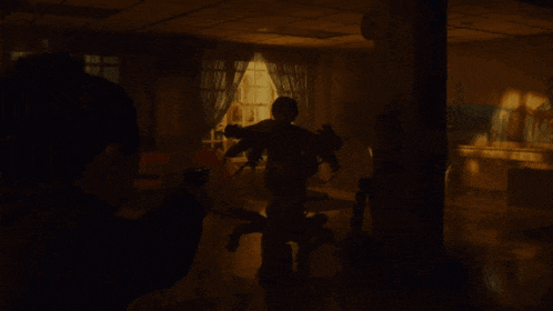 a dark room with a person standing in the middle