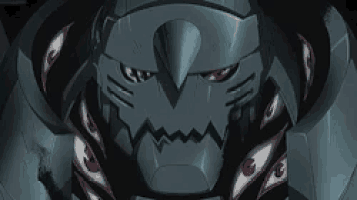 a close up of a robot 's face with many eyes coming out of it 's mouth .