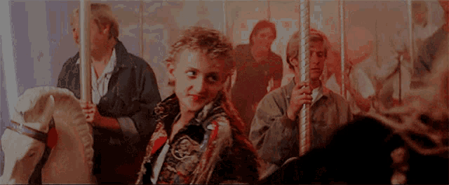 a group of people are riding a merry go round and one of them is wearing a jacket with a skull on it