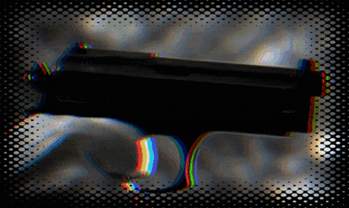 a blurry picture of a gun with a rainbow colored grip