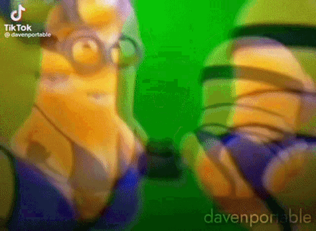 a couple of minions are standing next to each other on a green background .