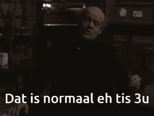 a woman in a blue robe is standing next to a man in a black shirt and says dat is normaal