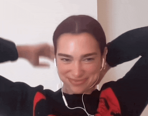a woman wearing headphones is making a face