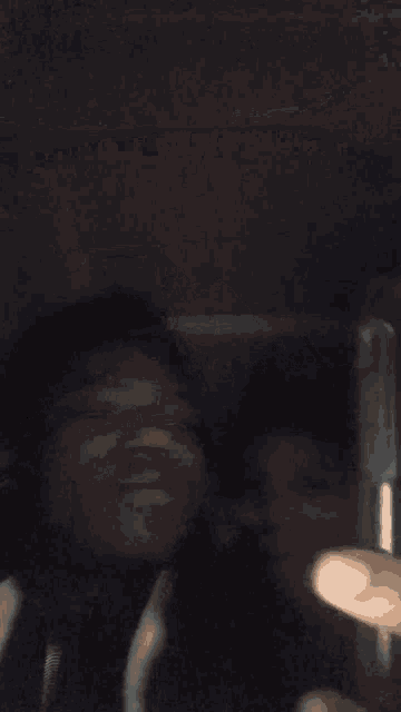 a blurry picture of two people standing next to each other in a dark room