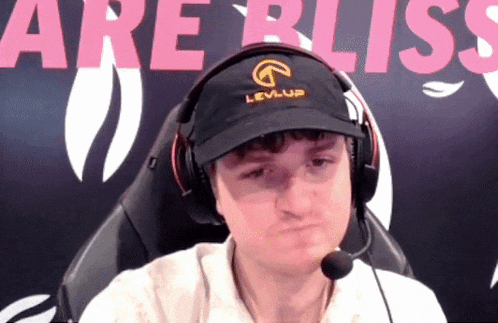a man wearing headphones and a levi-up hat