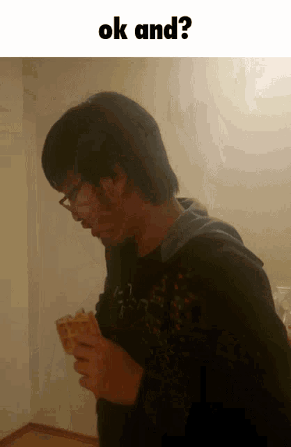 a man holding a piece of food with the words ok and written below him