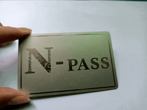 a person holding a card that says n-pass