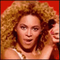 a close up of a woman 's face with blonde curly hair
