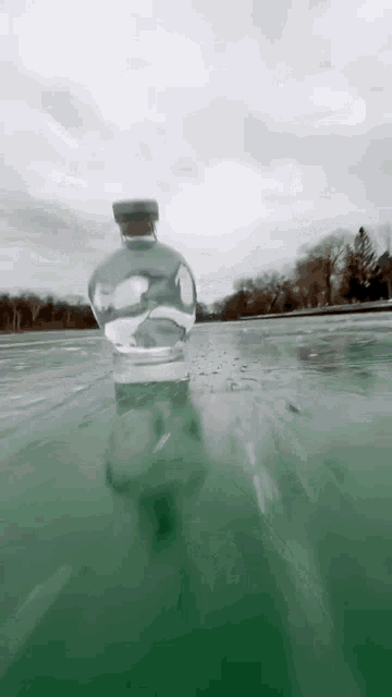 a bottle of water is floating in a body of water