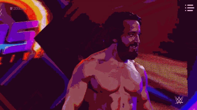 a shirtless wrestler is giving a thumbs up in front of a sign that says w