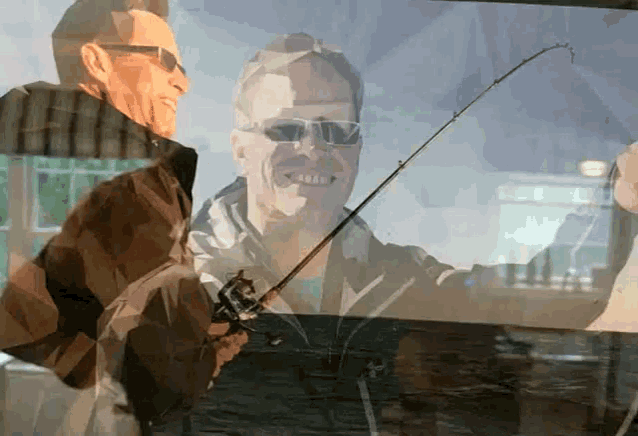 a man in sunglasses is holding a fishing rod and smiling